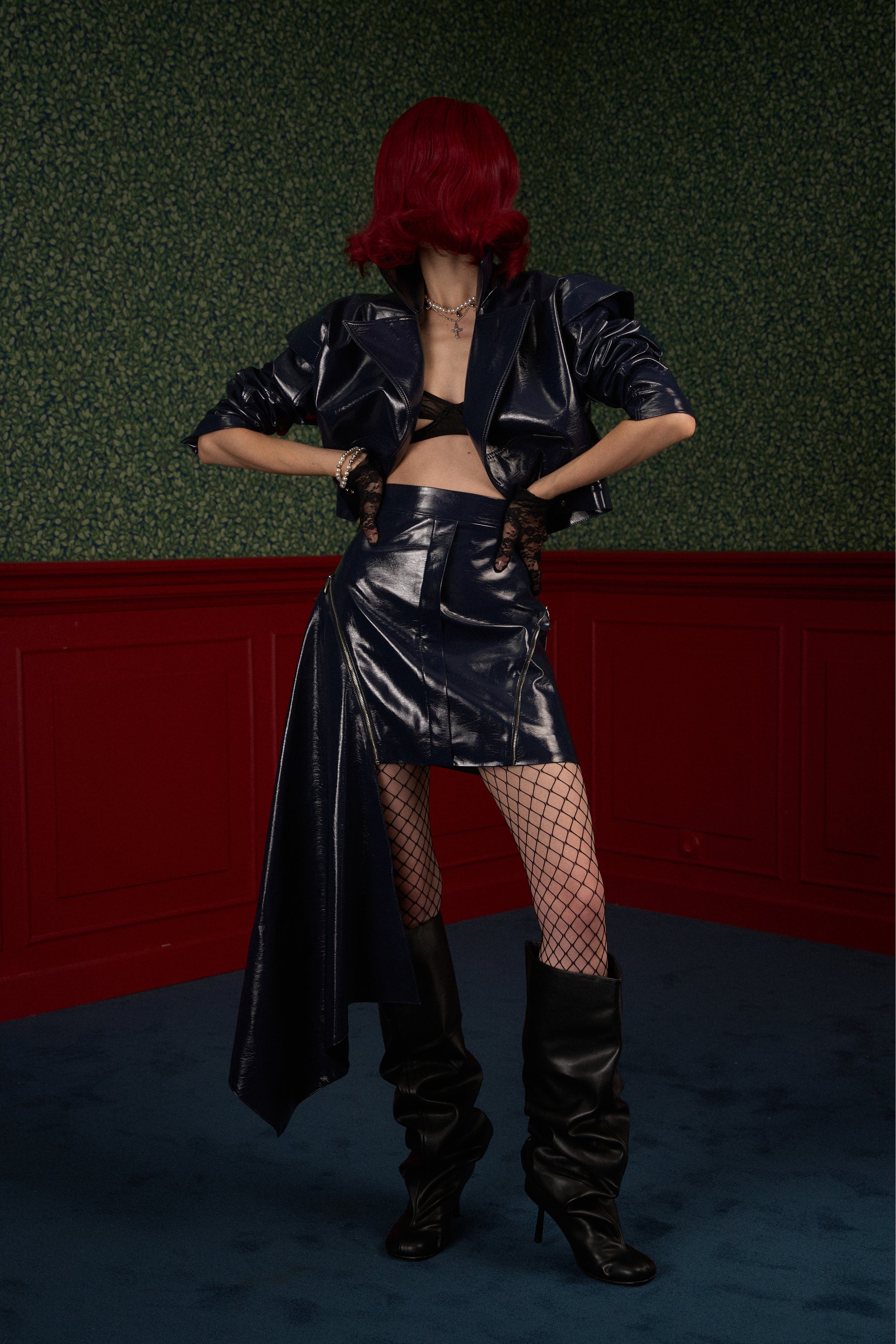 Model wearing Naked Doll navy asymmetric vegan leather skirt "The Weapon" with jacket.