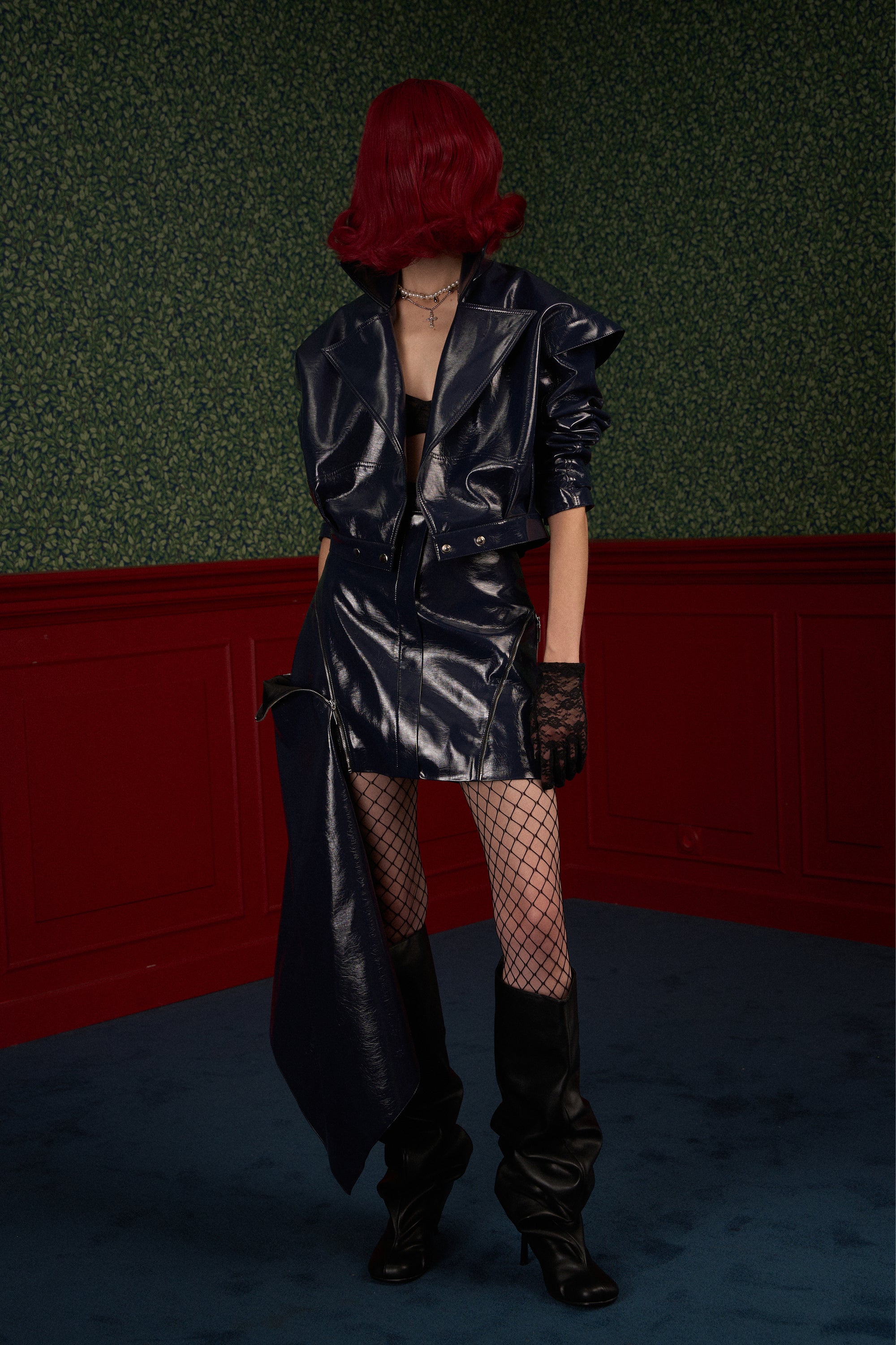 The Weapon" navy asymmetric skirt styled with matching jacket, with the side zipper partially open.