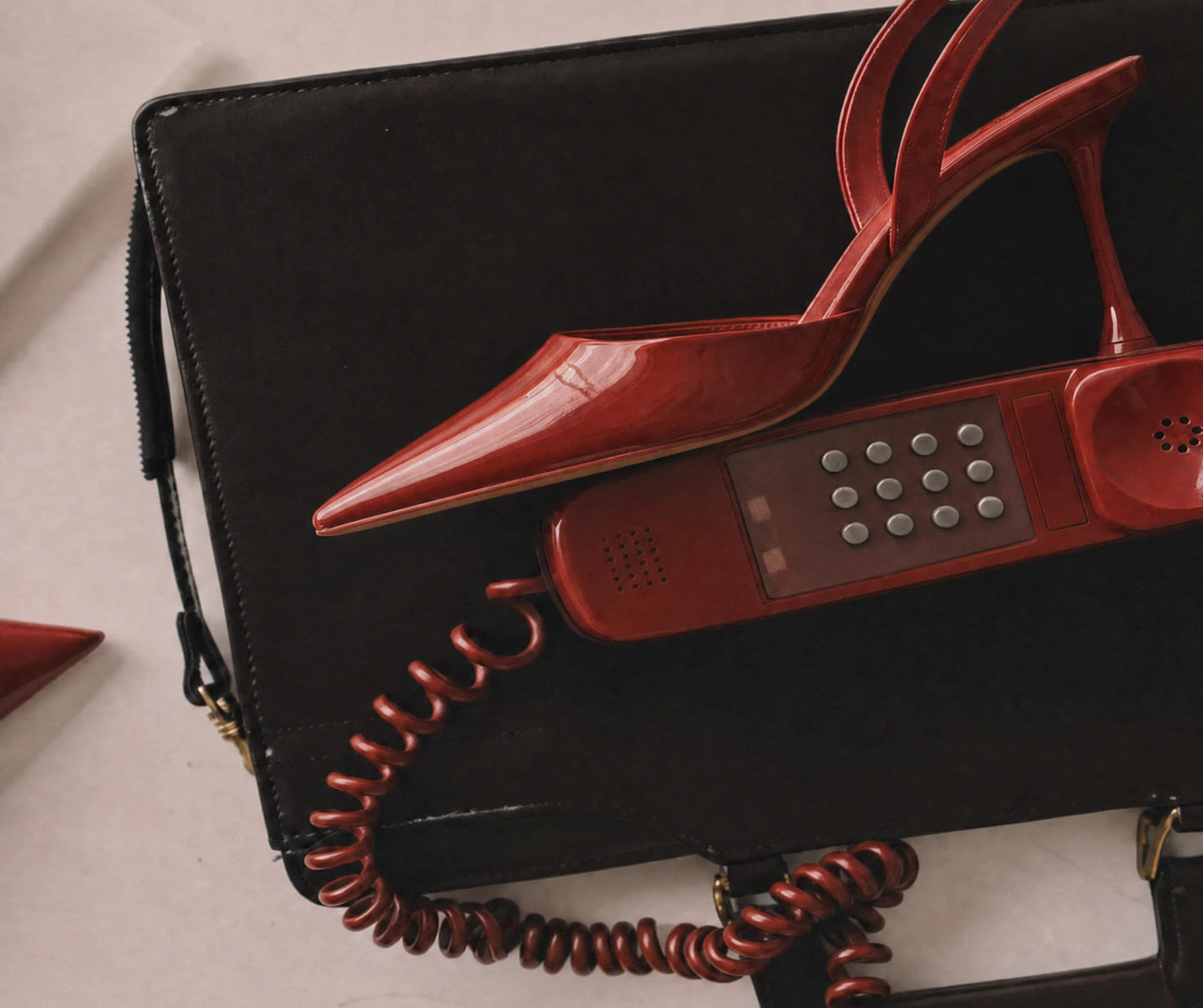 Red shoe and black handbag editorial detail